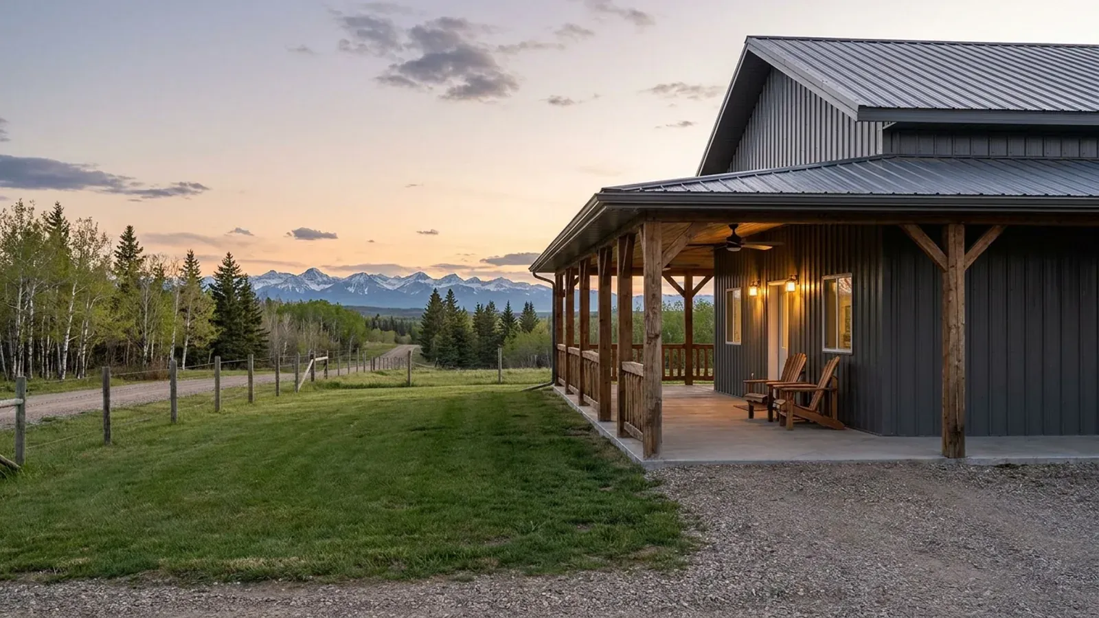 A barndominium exterior showing a deep wrap-around covered porch with timber posts and railing along two sides of the building.